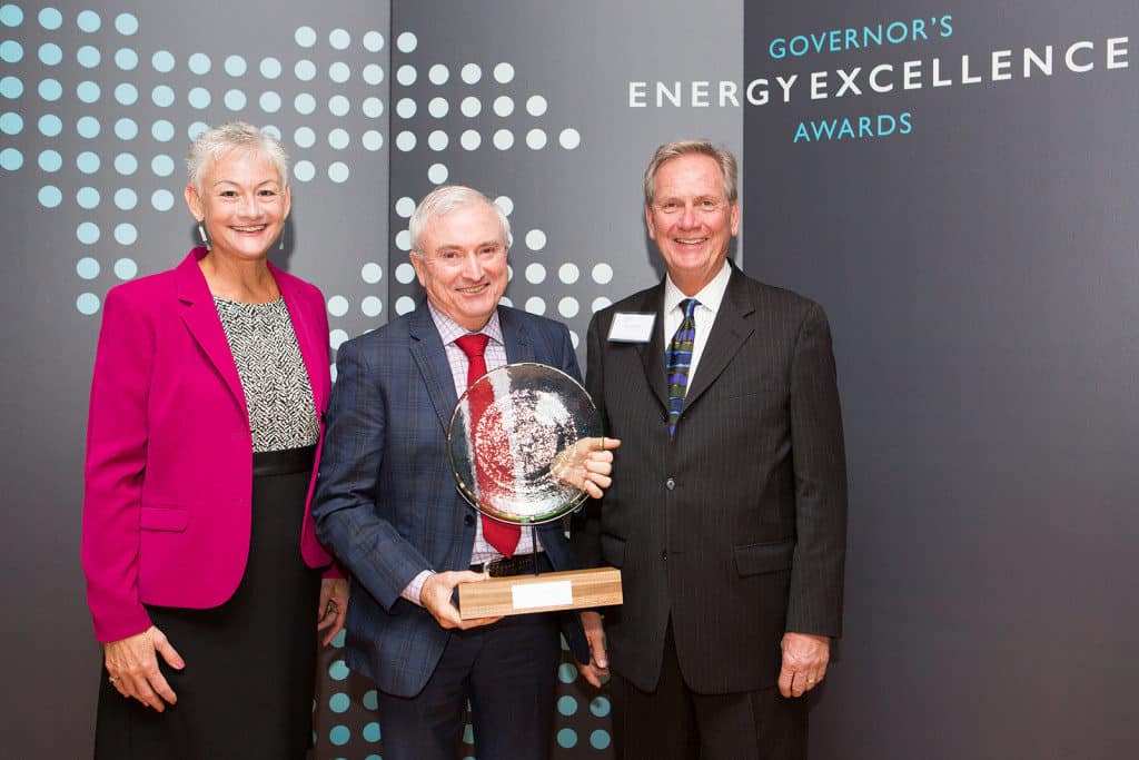 A Governor's Energy Excellence Award recipient holding his trophy