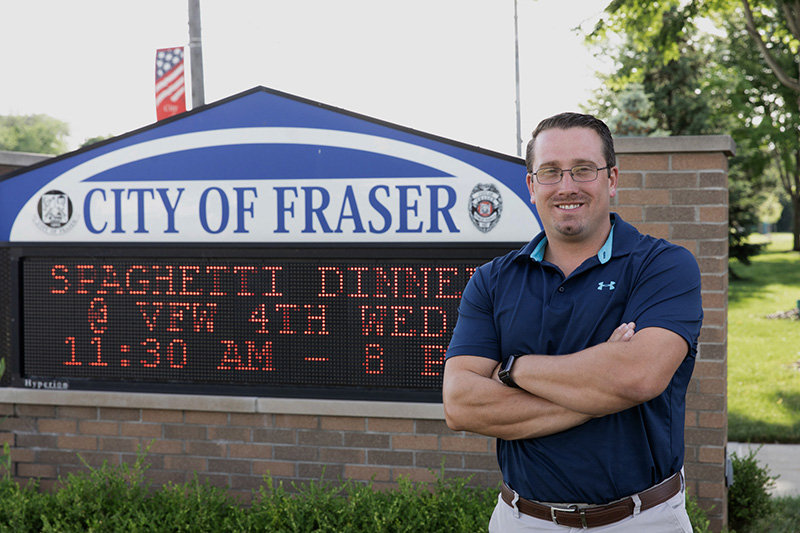 Nick Schaefer, Fraser, Michigan's public works supervisor stands in front of the city sign